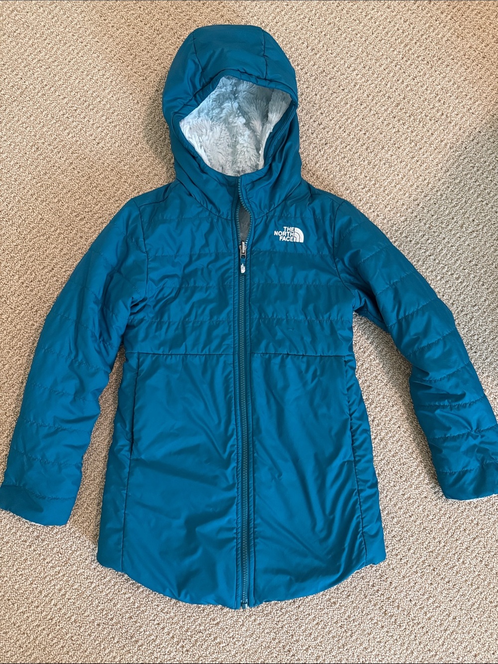 The North Face Teal Hooded Kids Puffer Coat. Small stain on back.